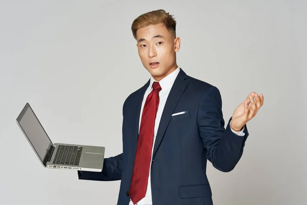 Business man of asian appearance in suit with laptop technology — Stockfoto