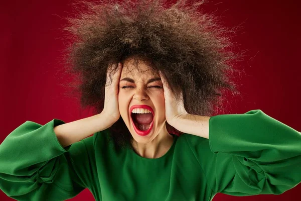 Young woman grimace afro hairstyle red lips fashion studio model unaltered Stock Image