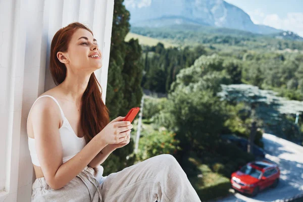 Portrait woman with a red phone Terrace outdoor luxury landscape leisure Relaxation concept — Fotografia de Stock