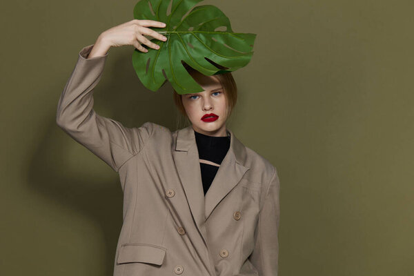portrait of a woman red lips palm leaf charm fashion green background