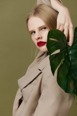 glamorous woman in coat red lips fashion palm leaf Lifestyle posing
