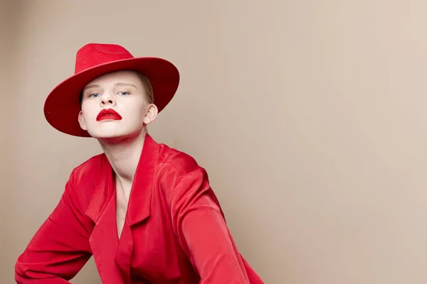 Pretty woman red jacket and hat red lips fashion studio model unaltered — Fotografia de Stock