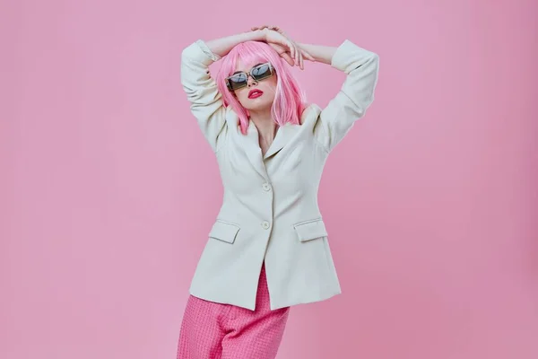 Positive young woman wearing sunglasses pink hair posing color background unaltered — Stok fotoğraf