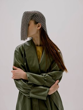 photo pretty woman fashion leather coat glamor chain mail light background