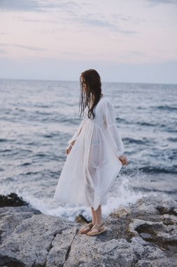 Beautiful woman walks volcanic rock formations on the island nature