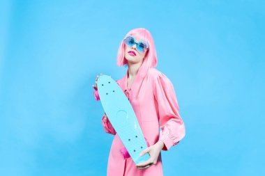 pretty woman with skateboard in pink wig studio model unaltered