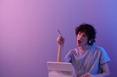 man cyberspace playing with headphones in front of a laptop isolated background