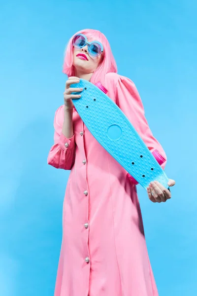 Fashionable woman fashion blue glasses skateboard studio model unaltered — Stockfoto
