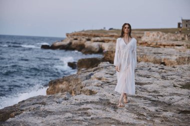 Beautiful woman walks volcanic rock formations on the island Lifestyle unaltered