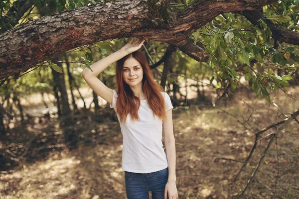 Woman touching tree branch with hands on nature in garden summer lifestyle and fresh air — Stock Photo, Image