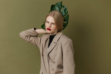 glamorous woman with  red lips with  palm leaf on  isolated background. High quality photo