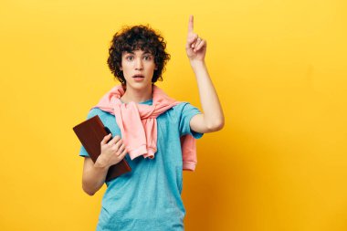 curly guy with a book college learning pink jacket isolated backgrounds