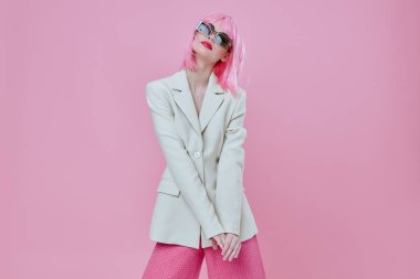 Portrait of a charming lady wearing sunglasses with  pink hair posing. High quality photo