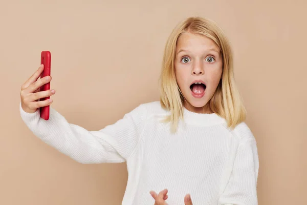 Little cute girl talking on the phone technology posing studio — Stockfoto