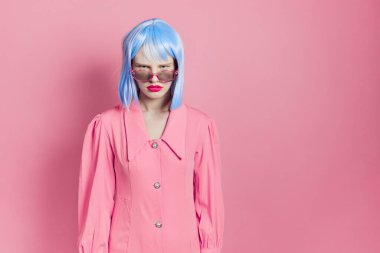 Mavi peruklu çekici kadın. Pembe elbiseli, kırmızı dudaklı stüdyo modeli.