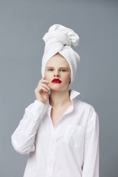 Portrait of a woman white shirt cosmetics with towel on head Lifestyle posing Stock Image