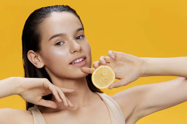 Young woman half a lemon vitamins health cosmetology close-up Lifestyle — Stock Photo, Image