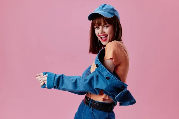 Beauty Fashion woman in a cap and denim jacket posing color background unaltered — Stockfoto