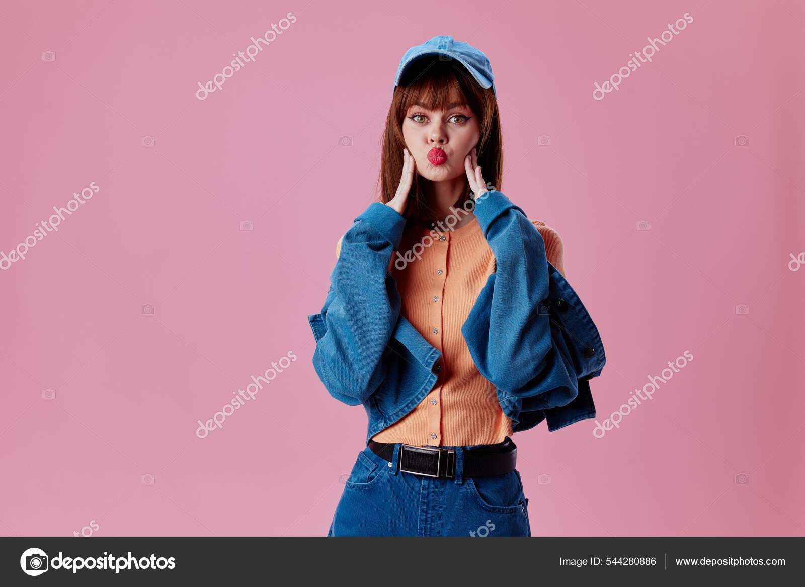 Pretty young female denim clothing fashion posing cap color background  unaltered Stock Photo