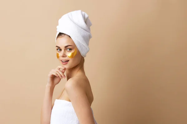 Wanita cantik perawatan wajah wajah tambalan bahu telanjang higienitas latar beige — Stok Foto