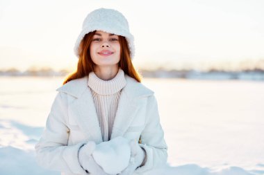 Güzel bir kadın kızıl saçlı kar tarlası kışlık giysiler güneşli kış günü yaşam tarzı
