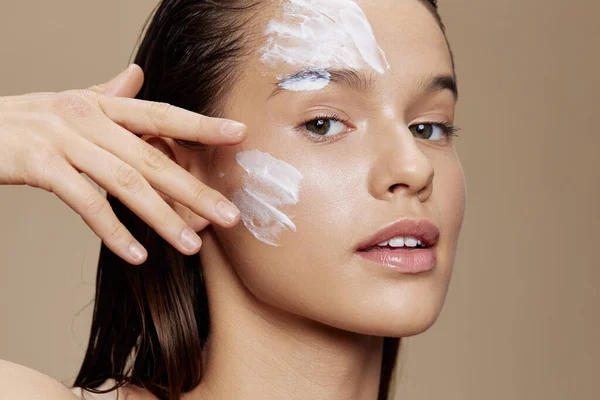 portrait woman applying a soothing face mask cosmetic isolated background