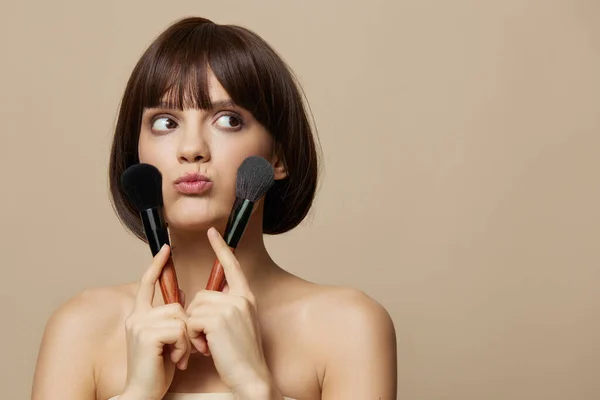 Frau Make-up Pinsel in der Nähe des Gesichts nackte Schultern abgeschnittene Ansicht — Stockfoto