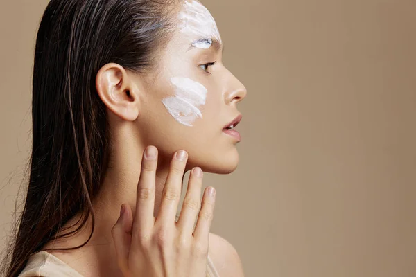 woman applying a soothing face mask cosmetic isolated background