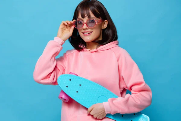 핑크 스웨터를 입고 스케이트 보드 엔터 테인 먼 트를 즐기는 젊은 여성 이 배경을 분리 했다 — 스톡 사진