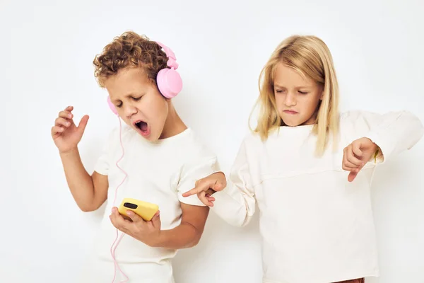 Two preschool children boy and girl headphones with phone entertainment lifestyle childhood — Stock Photo, Image