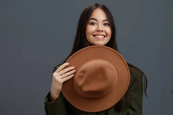 Bela mulher em um terno com um chapéu posando casual desgaste Cinza fundo — Fotografia de Stock