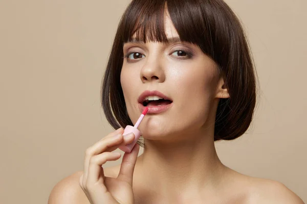 Brünettes Make-up Lipgloss nahe dem Gesicht nackte Schultern Nahaufnahme Lifestyle — Stockfoto