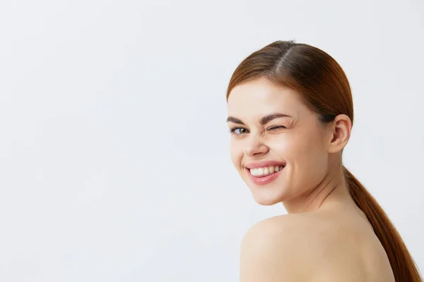 Mooie vrouw rood haar kale schouders cosmetica huidverzorging licht achtergrond — Stockfoto
