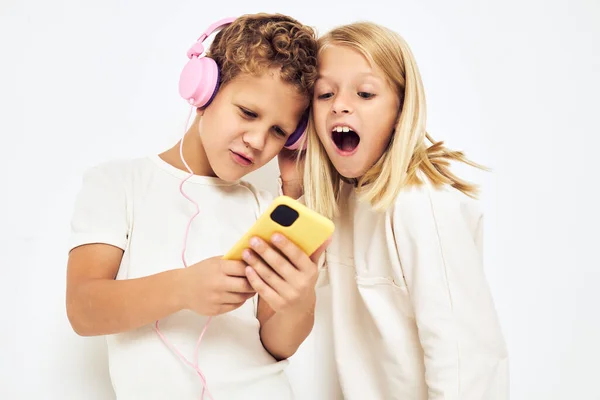 Obrázek chlapce a dívky sluchátka s telefonem zábavy životního stylu dětství — Stock fotografie