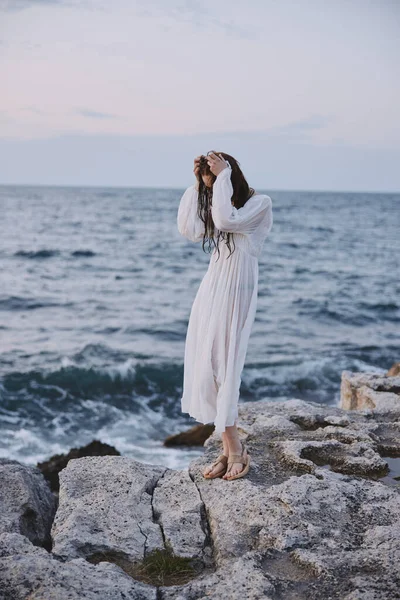 Pretty woman by the ocean stones walk travel — Stock Photo, Image