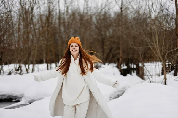 woman in winter clothes in a hat fun winter landscape Walk in the winter forest