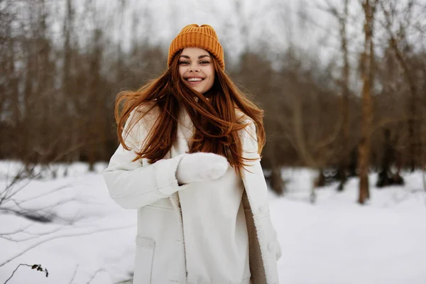 young woman in winter clothes in a hat fun winter landscape Lifestyle