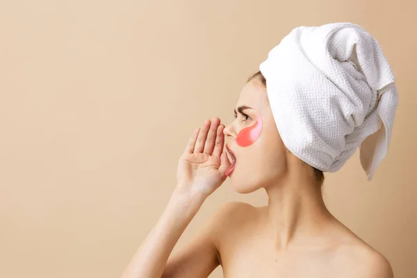 Mujer parches rejuvenecimiento cuidado de la piel divertido fondo beige — Foto de Stock