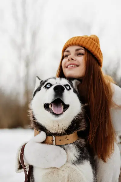 woman with dog winter landscape walk friendship winter holidays