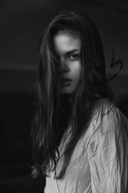 Dışarıda poz veren çekici bir kadın. Siyah beyaz bir fotoğraf.