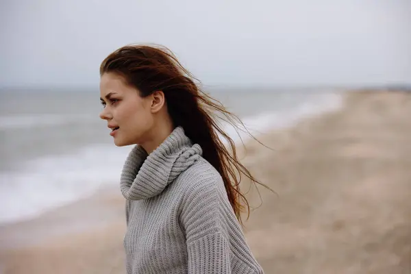portrait of a woman cloudy weather by the sea travel fresh air Lifestyle. High quality photo
