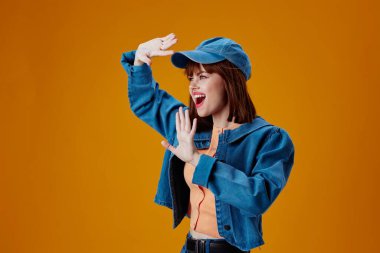 Beautiful fashionable girl denim cap red lips glamor fashion color background unaltered. High quality photo