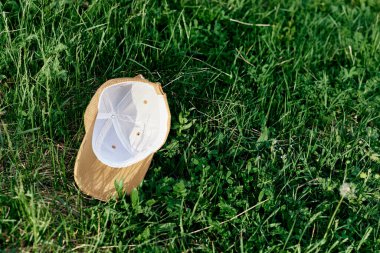 Spor şapkası taze yeşil çimlerin üzerinde yatar. Yüksek kalite fotoğraf