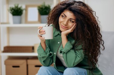 Mutlu şirin, bronzlaşmış, kıvırcık Latin bayandan hoşlanıyordu. Sevgiyle bakıyordu. Rahat gömlekli bir fincan çay kahvesi tutuyordu. Uzay Sancağını kopyala. Güzel anılar