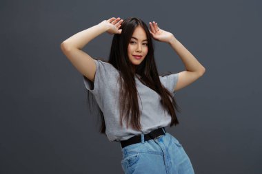 Gençlik tarzı pozlar veren tişörtlü ve kot pantolonlu kadın portresi. Yüksek kalite fotoğraf