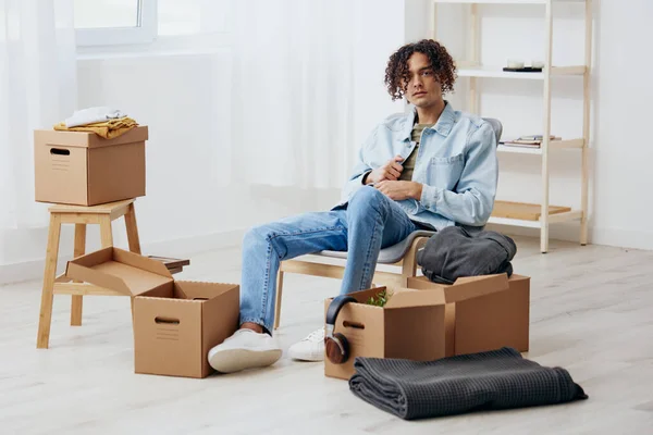 Chico Guapo Sentado Una Silla Desempacar Con Caja Mano Moviendo —  Fotos de Stock