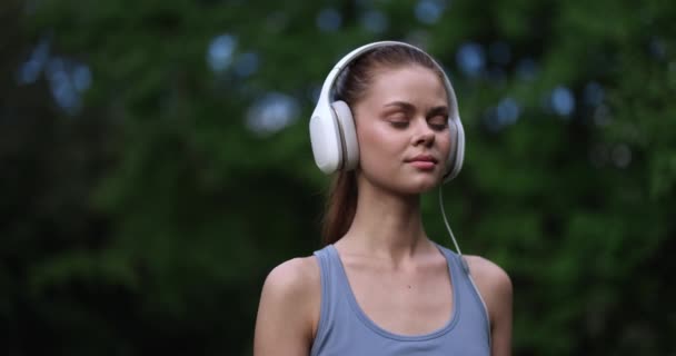Vrouw Met Grote Witte Hoofdtelefoon Luistert Naar Haar Favoriete Muziek — Stockvideo