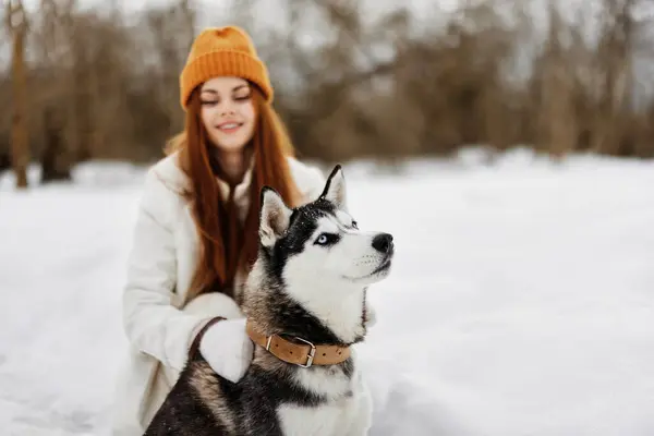 woman with dog outdoor games snow fun travel fresh air. High quality photo