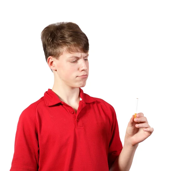 Teen boy looks at a cigarette — Stock Photo, Image