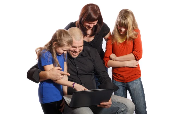 Smiling happy family looking at computer — Stock Photo, Image